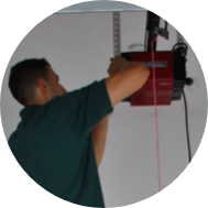 Precision Door Service technician fixing a garage door opener