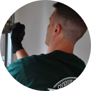 Precision Door Service technician fixing a garage door